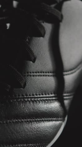 Vertical-Video-Studio-Still-Life-Shot-Of-Football-Soccer-Boots-Against-Black-Background-1